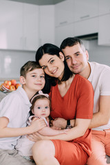 Happy family sitting on couch at home