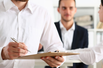 Male arm in suit hold silver pen