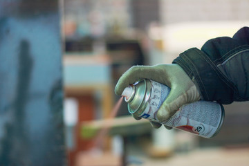 man working with spray can