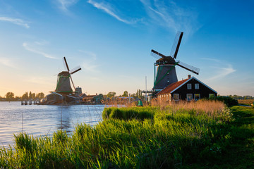Naklejka premium Windmills at Zaanse Schans in Holland on sunset. Zaandam, Netherlands