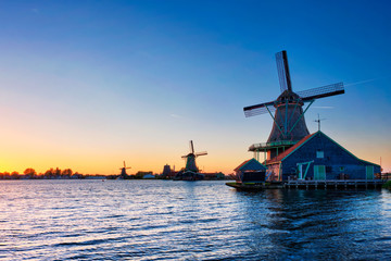 Fototapeta na wymiar Windmills at Zaanse Schans in Holland on sunset. Zaandam, Netherlands