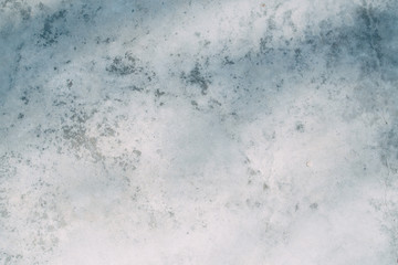 The texture of old white concrete. Sunlight and shadows on the wall.