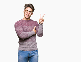 Young handsome man wearing glasses over isolated background smiling with happy face winking at the camera doing victory sign. Number two.