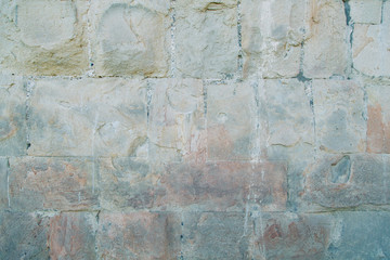 Fototapeta premium Texture of old masonry walls in Georgia. Sunlight and shadows from the leaves on the bricks.