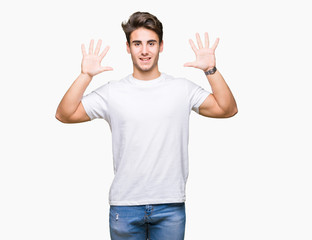 Naklejka premium Young handsome man wearing white t-shirt over isolated background showing and pointing up with fingers number ten while smiling confident and happy.