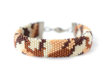 Desert camouflage beaded bracelet isolated on white background close up