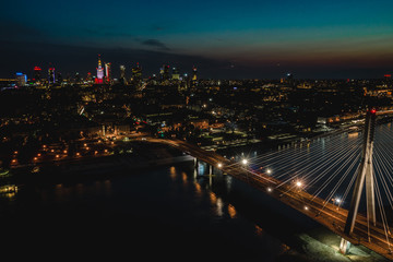 Beautiful Warsaw city at night with bridge.