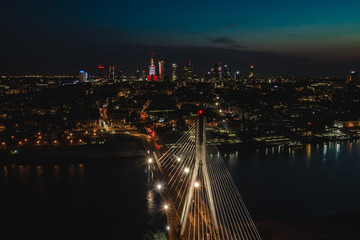 Beautiful Warsaw city at night with bridge.