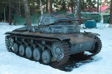 German battle tank 2nd World War Tiger in the snow under the trees.