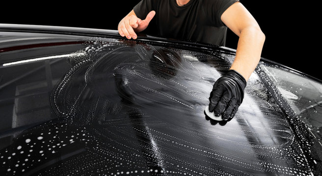 A Man Cleaning Car With Microfiber Cloth. Car Detailing Or Valeting Concept. Selective Focus. Car Detailing. Cleaning With Sponge. Worker Cleaning. Car Wash Concept Solution To Clean