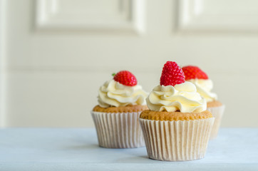 Home Baked Iced Cupcakes With Red Berries