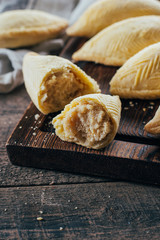 Azerbaijan national dessert. Oriental Sweet Pastry Dessert - Shekerbura on wooden board on wooden table background