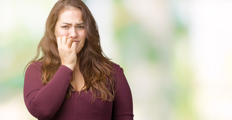 Obraz premium Beautiful and attractive plus size young woman wearing a dress over isolated background looking stressed and nervous with hands on mouth biting nails. Anxiety problem.