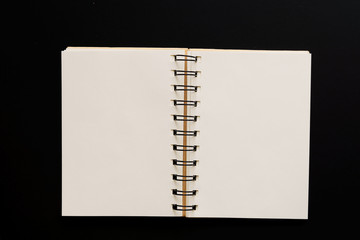 Design concept - Top view of empty kraft notebook on black background. mock up.