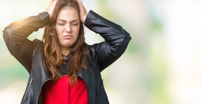 Beautiful plus size young woman wearing a fashion leather jacket over isolated background suffering from headache desperate and stressed because pain and migraine. Hands on head.