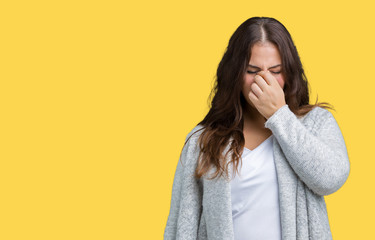 Beautiful plus size young woman wearing winter jacket over isolated background tired rubbing nose and eyes feeling fatigue and headache. Stress and frustration concept.