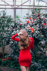 Beautiful young slim girl in the blooming garden