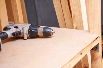 Assembling of furniture, closeup of tool in hand