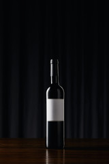 WIne bottle with blank label on wooden surface