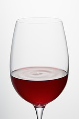 Wine glass with burgundy red wine isolated on white