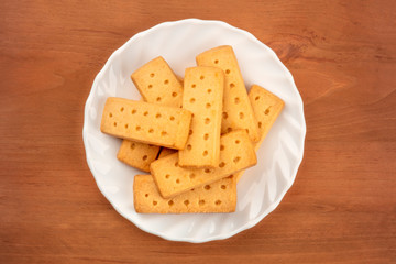A photo of Scottish shortbread butter cookies, shot from the top on a rustic wooden background with a place for text