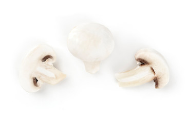 Fototapeta na wymiar Three champignon mushrooms, shot from above on a white background, a flat lay composition with a place for text