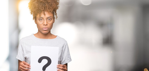 Young african american woman holding paper with question mark over isolated background with a confident expression on smart face thinking serious