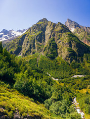 Obraz premium Mountains with cliffs in the summer, sunny day. In the surroundings of domby. Caucasus Mountains.