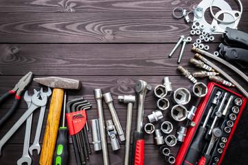 tools and auto spare parts on wooden workbench. copy space