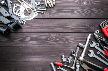 tools and auto spare parts on wooden workbench. copy space