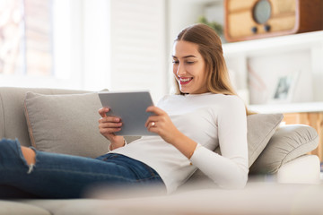Young woman using digital tablet at home