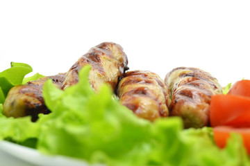 fried sausages and salad on a white plate