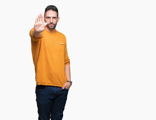 Young handsome man over isolated background doing stop sing with palm of the hand. Warning...