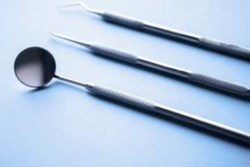 Dental instrments on blue. Dental care concept. Dental treatment.