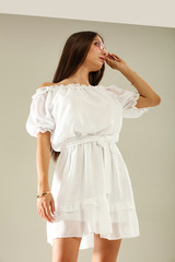 Slim young woman in white summer dress 