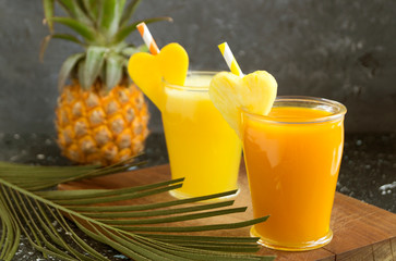 Pineapple juice in a jar with a straw.