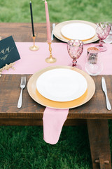 Elegant black and pink table setting for wedding reception with bouquets
