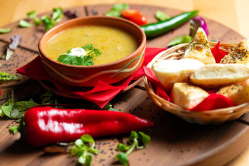 Cream soup in ceramic bowl on wooden table