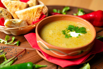 Cream soup in ceramic bowl on wooden table