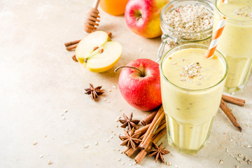 Healthy breakfast, snack. Spicy  smoothie with apple, honey, oatmeal, cinnamon, anise. Light concrete background copy space
