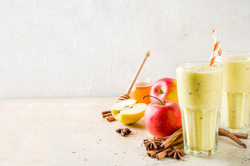 Healthy breakfast, snack. Spicy  smoothie with apple, honey, oatmeal, cinnamon, anise. Light concrete background copy space