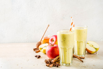 Healthy breakfast, snack. Spicy  smoothie with apple, honey, oatmeal, cinnamon, anise. Light concrete background copy space