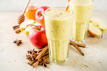 Healthy breakfast, snack. Spicy  smoothie with apple, honey, oatmeal, cinnamon, anise. Light concrete background copy space