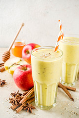Healthy breakfast, snack. Spicy  smoothie with apple, honey, oatmeal, cinnamon, anise. Light concrete background copy space