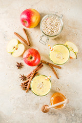 Healthy breakfast, snack. Spicy  smoothie with apple, honey, oatmeal, cinnamon, anise. Light concrete background copy space