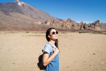 Pretty brunette girl walking outdoor near teide volcano on tenerife island.