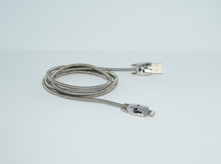 silver metal cable on a white background, cable with 8 pin connector
