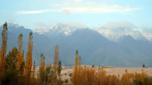 Landscape view of snow capped mountain range and Katpana cold desert in early morning. Autumn scene in Skardu, Gilgit Baltistan, Pakistan.