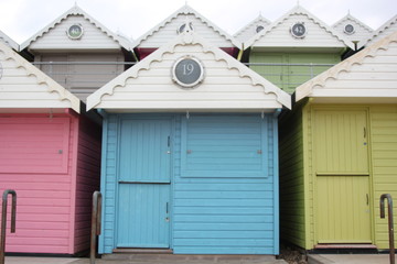 Naklejka na ściany i meble Beach huts at Walton on the Naze, Beach Huts, Essex, England, beach huts are traditional seaside feature for people to change or base themselves. Walton-on-naze, Essex, UK