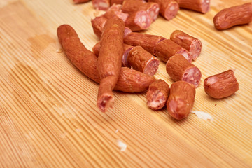 A variety of processed cold meat products, on a wooden cutting board